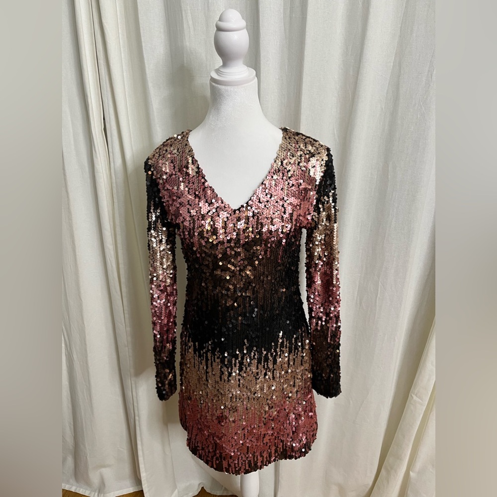 This sequin dress has shades of pink , black, brown